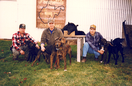 Phil Hill, Eugene Walker, and Sam Walker with hounds